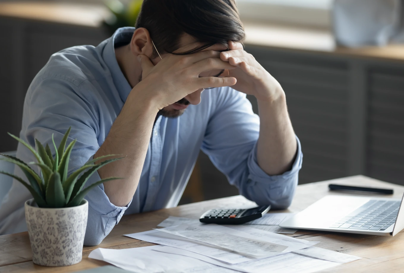 A stressed founder reviewing paperwork at a desk